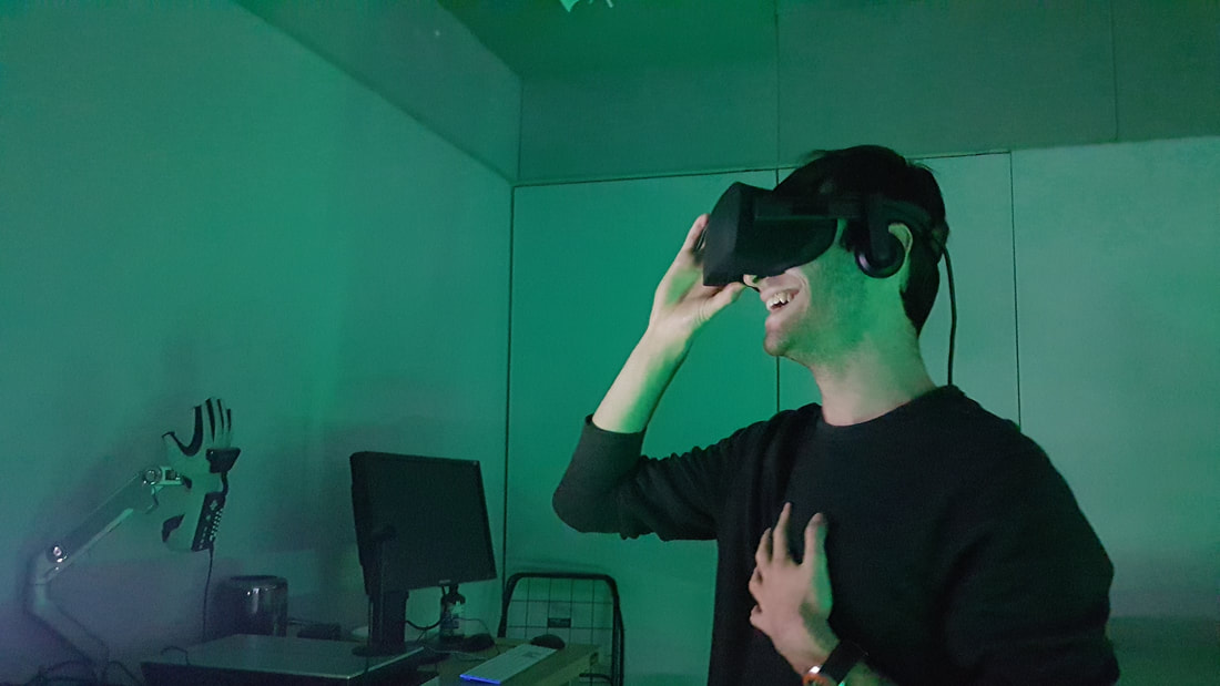 Picture young guy with Oculus emotional reaction. He is laughing and smiling
